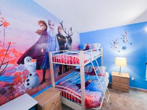 a bedroom with a disney mural on the wall at Luxurious Private Heated Pool Villa Close to Disney in Davenport