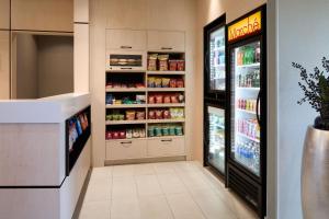 a kitchen with an open refrigerator with food at Fairfield Inn & Suites by Marriott Montreal Airport in Dorval