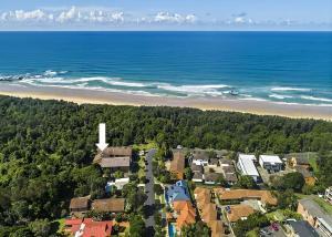 an aerial view of a town next to a beach at Banksia in Sawtell