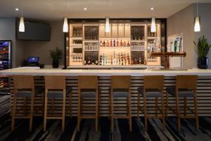a bar at a restaurant with chairs around it at Fairfield Inn & Suites by Marriott Montreal Airport in Dorval