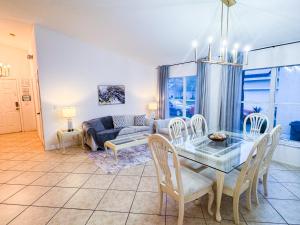 a living room with a table and chairs and a couch at Luxurious Private Heated Pool Villa Close to Disney in Davenport