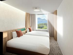 Postel nebo postele na pokoji v ubytování Minakami Kogen Hotel 200