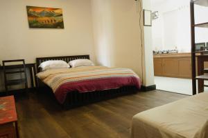 Rúm í herbergi á Cocina Mitho Chha BNB