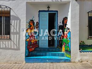 a mural on the side of a building with a door at Apartment Dreaming with Art - Mojacar Pueblo in Mojácar