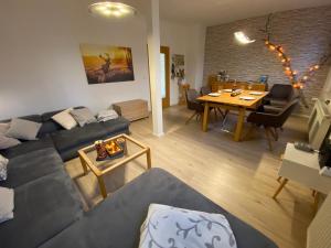 a living room with a couch and a table at Ferienwohnung am Anger in Wernigerode