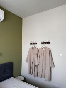 a bedroom with two coats hanging on a wall at Smart Comfort RoomN7 with Private Bathroom in best Location Beach 250m in Limassol +13 photos