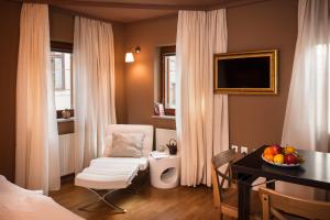 a hotel room with a desk and a chair and a table at City Centre Apartments in Ljubljana