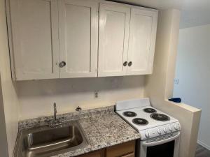 a kitchen with a sink and a stove at Cozy 1-Bedroom Apartment in Roy in Roy