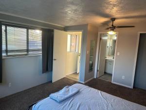 a bedroom with a bed and a ceiling fan at Cozy 1-Bedroom Apartment in Roy in Roy +8 photos