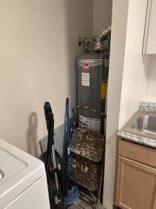 a corner of a kitchen with a refrigerator and tools at Cozy 1-Bedroom Apartment in Roy in Roy