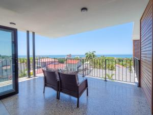 a balcony with two chairs and a view of the ocean at The Lofts on Manaar in Durban