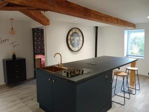 a kitchen with a sink and a counter top at Le Boulary in La Monnerie-le Montel