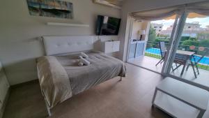 a bedroom with a bed with a teddy bear on it at VIDABRAVA, Sagaro garden loft in S'Agaro