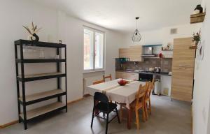 a kitchen and dining room with a table and chairs at Appartamento - Cave del Predil in Cave del Predil