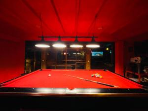 a pool table in a room with red lighting at King Fern Cottage in Nuwara Eliya