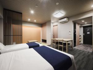 a hotel room with two beds and a table at MONday Apart Premium UENO OKACHIMACHI in Tokyo +55 photos