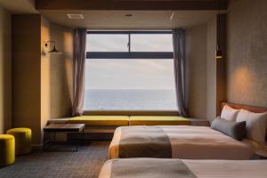 Postel nebo postele na pokoji v ubytování Uenimo Onsen Hotel Shirahama