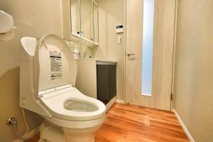 a bathroom with a toilet with the lid up at ZJ202 Hanama202 The Skytree Residence A Newly Home by Tokyo Iconic Landmarks in Tokyo +36 photos