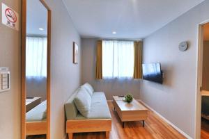 a living room with a couch and a table at ZJ202 Hanama202 The Skytree Residence A Newly Home by Tokyo Iconic Landmarks in Tokyo