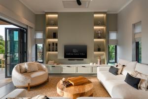 a living room with a tv on a wall at Villa Divano - by Sublime Samui Villas in Choeng Mon Beach