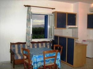 a kitchen with a table and a window at Baetylus in Kastraki