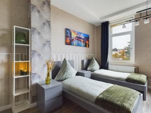 a bedroom with two beds and a window at OtterslebenGartenblick37 - Küche & Garten, bis zu 3 Personen in Magdeburg