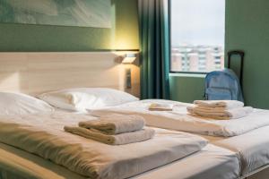 Postel nebo postele na pokoji v ubytování MEININGER Hotel Amsterdam City West