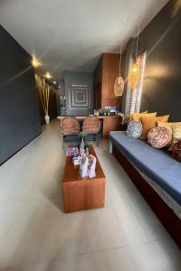 a living room with a couch and a coffee table at Bliss Resort Krabi in Klong Muang Beach