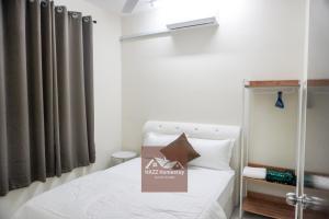 a small bedroom with a bed with a sign on it at HAZZ Homestay Kulim IV in Kulim