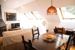 a dining room with a table with a plate of food on it at Casa Marco - esenciaaragon- Ático dúplex al lado de las estaciones de esquí in Canfranc