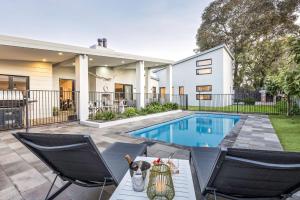 una casa con piscina e due sedie di Sunnysprings a Dunsborough