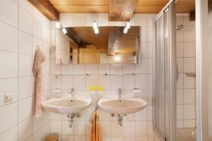 a bathroom with two sinks and a mirror at Krährbauernhof mit Eventraum 3 fewo in Hornberg +12 photos
