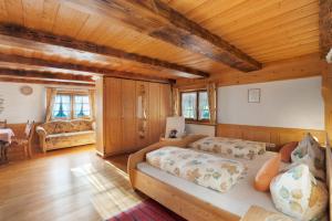 a bedroom with two beds in a room with wooden ceilings at Krährbauernhof mit Eventraum 3 fewo in Hornberg