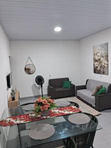 a living room with a table and a couch at Residecial Málaga 01 in Sinop
