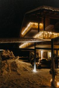 a house with christmas lights on the roof at night at Salzbergalm in Berchtesgaden