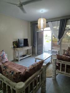 a living room with a couch and a table at Daffi giraffi House in Malindi