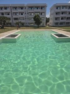 a large pool of water in front of a building at Daffi giraffi House in Malindi