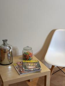 a table with a magazine and a glass jar on it at Hotel Restaurante El Colono in Gallur