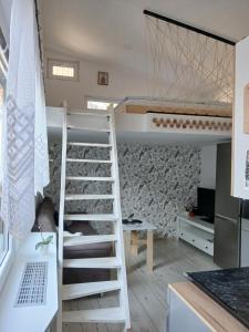 a room with two bunk beds and a ladder at Malý Domek in Dobré