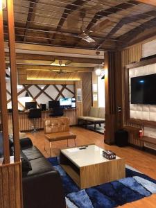 a living room with a couch and a tv at Millennium in Fuvahmulah