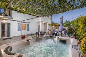 a hot tub in the backyard of a house at Holiday home Dioniza in Gajana