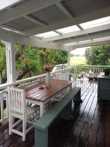 a wooden table and chairs on a deck at 95 on 15th in East London