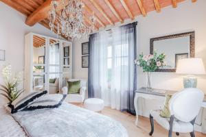 a bedroom with a bed and a chandelier at Villa Flora in Montecarlo +60 photos