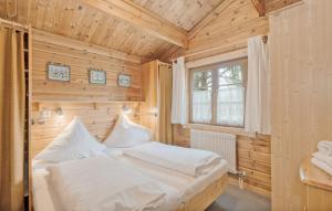 a bedroom with a bed in a wooden room at Ferienhaus Neckar 108 in Hayingen