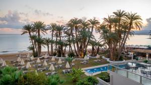 an aerial view of a resort with a pool and palm trees at Zeus Hotels Palm Beach in Stalís