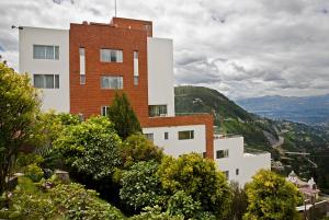 a large building with a view of the mountains at Hotel Stubel Suites & Cafe in Quito