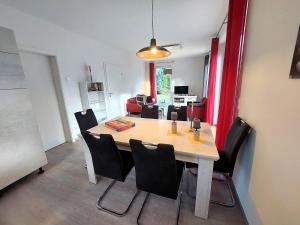 a dining room with a table and chairs at Ferienhaus "Unser neues Haus" in Trassenheide