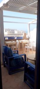 a room with a table and chairs and a table and a table at Tildi surf house in Imsouane