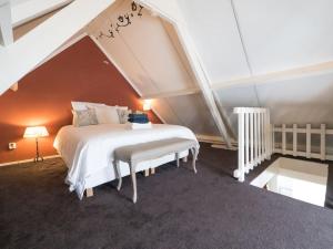 a bedroom with a white bed in an attic at Hosted by wendy Old city charming accommodation in Wassenaar