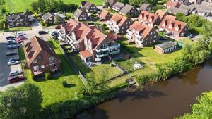 an aerial view of a house on a river at Oase am Siel 4 in Dornumersiel